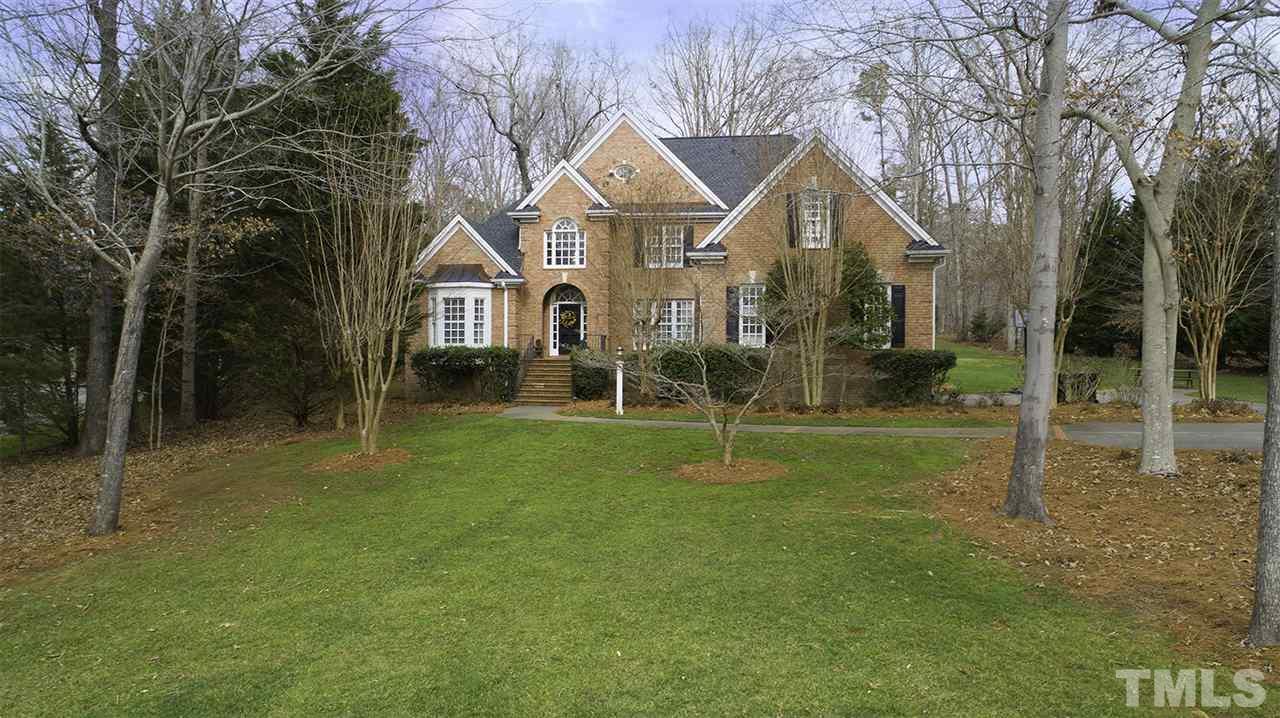 11208 Brass Kettle Road Raleigh, NC 27614 - Photo 1 of 25 a view of a big yard in front of a brick house with a big yard and large trees