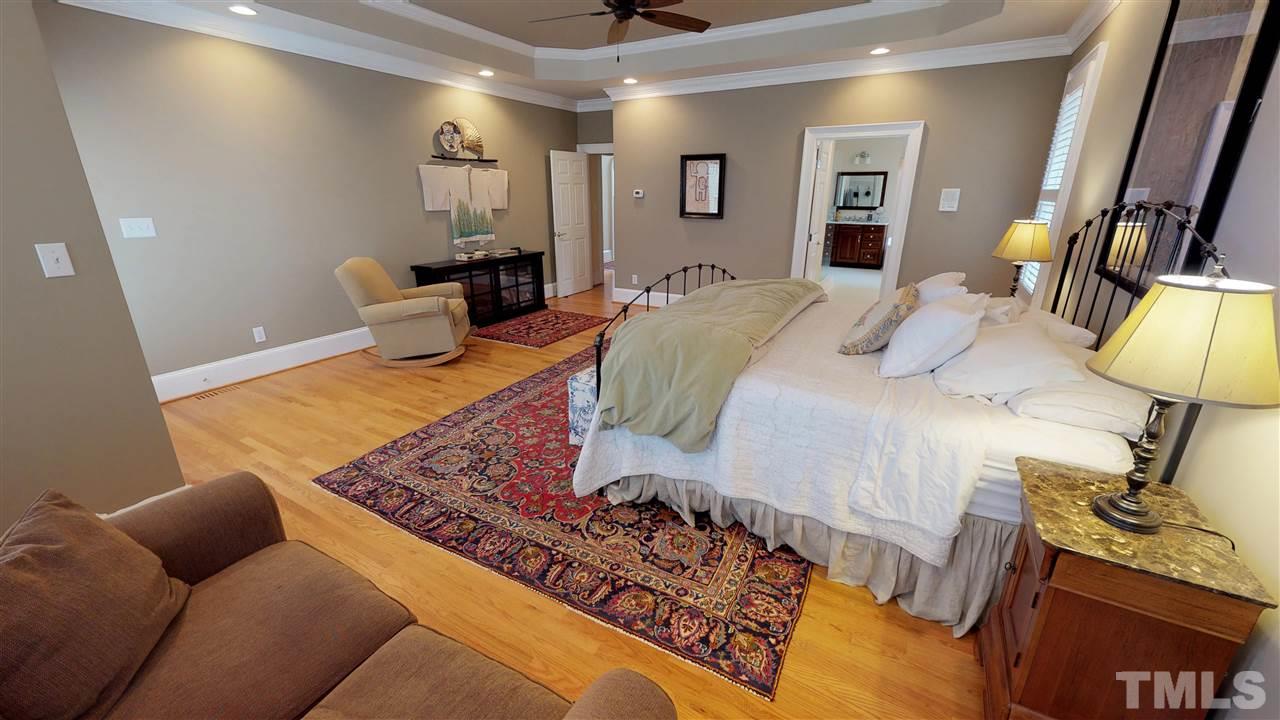 11208 Brass Kettle Road Raleigh, NC 27614 - Photo 14 of 25 a bed room with a bed furniture and a mirror