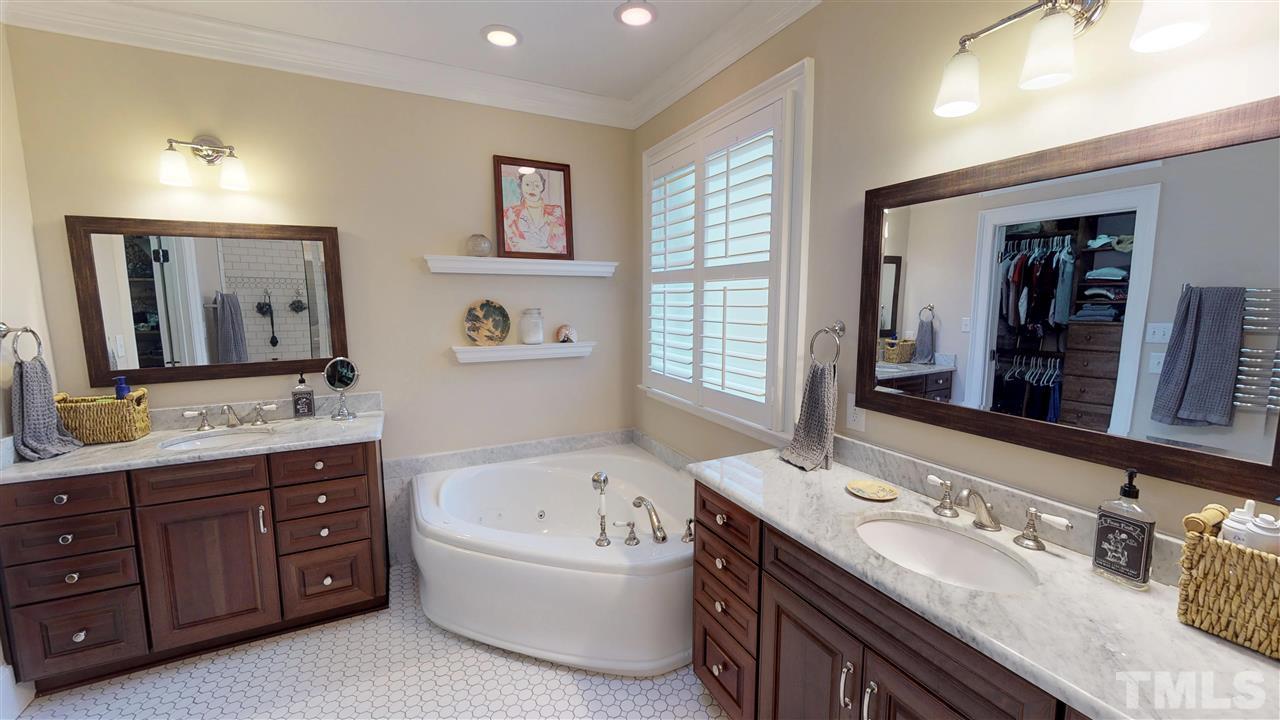 11208 Brass Kettle Road Raleigh, NC 27614 - Photo 15 of 25 a bathroom with a tub double vanity sink and a large mirror