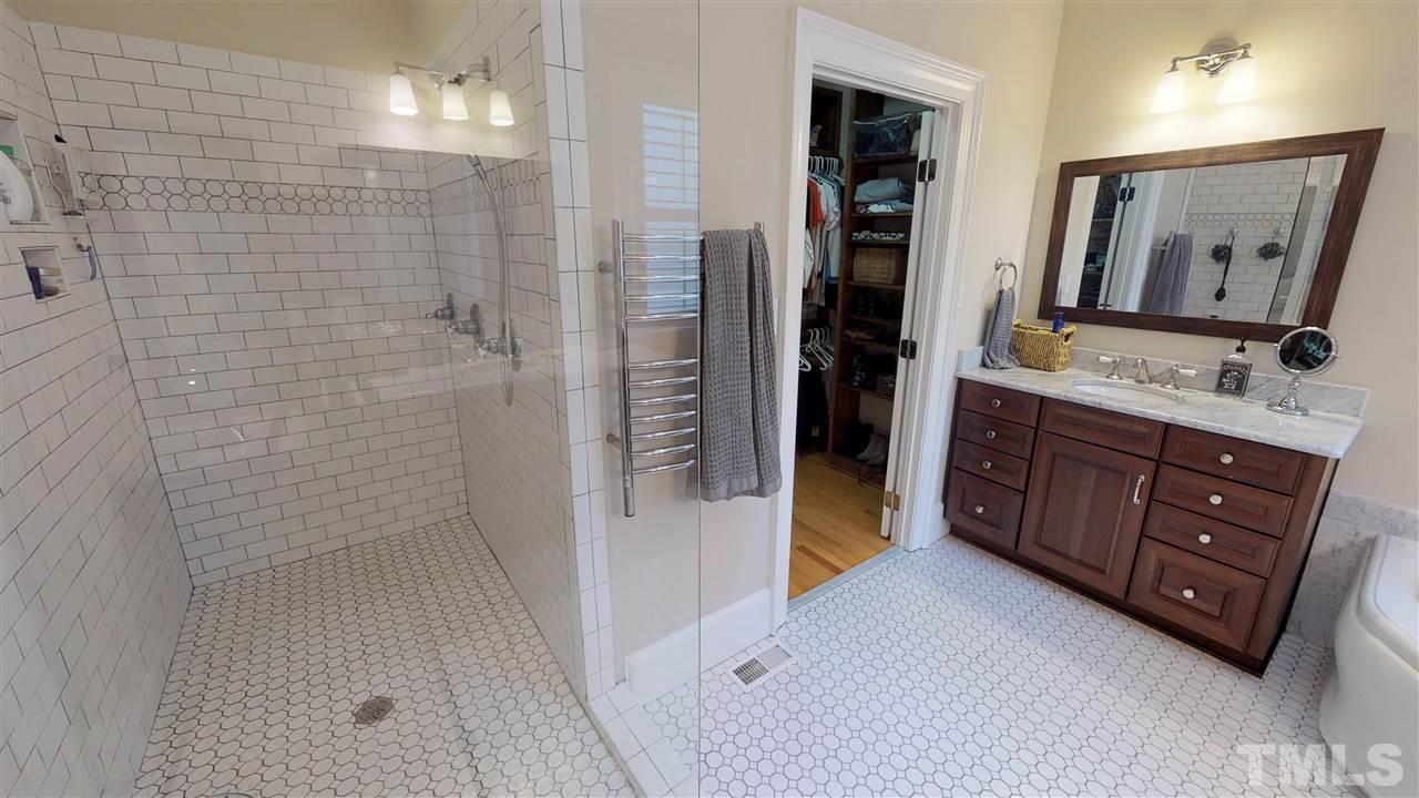 11208 Brass Kettle Road Raleigh, NC 27614 - Photo 16 of 25 a bathroom with a double vanity sink toilet mirror and shower