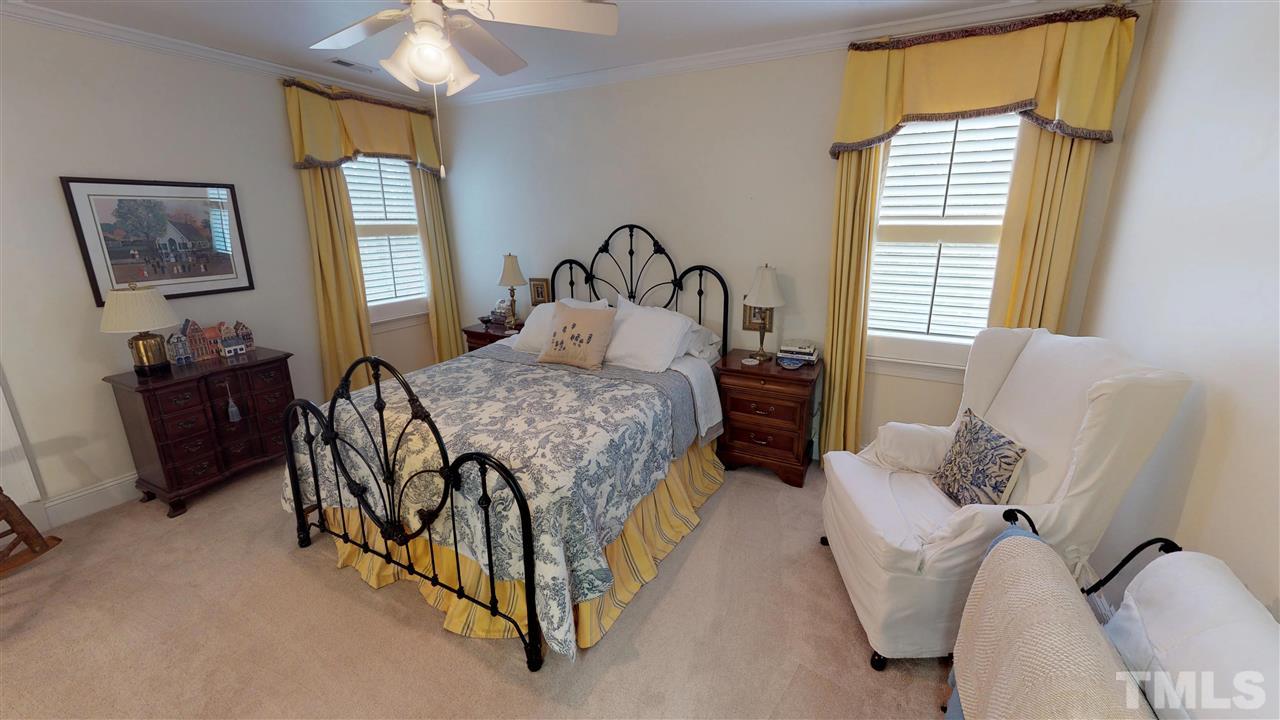 11208 Brass Kettle Road Raleigh, NC 27614 - Photo 18 of 25 a bedroom with a bed and a dresser