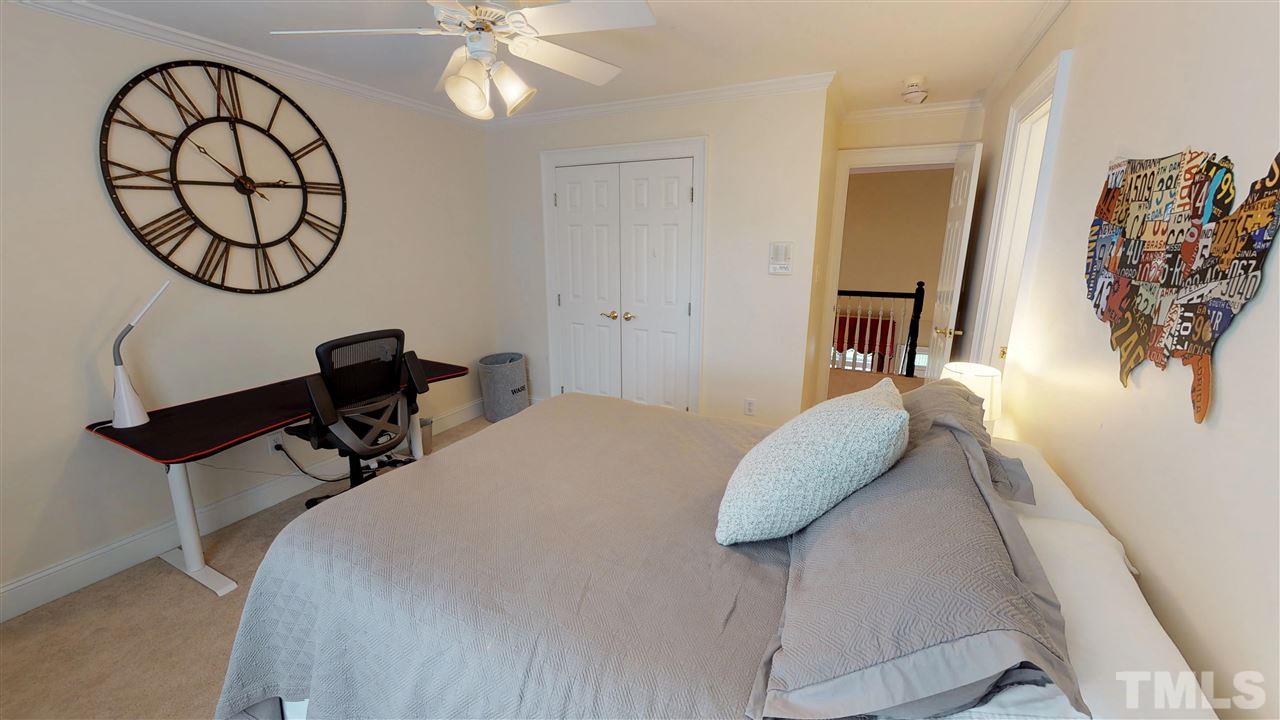 11208 Brass Kettle Road Raleigh, NC 27614 - Photo 19 of 25 a bedroom with bed and a chandelier