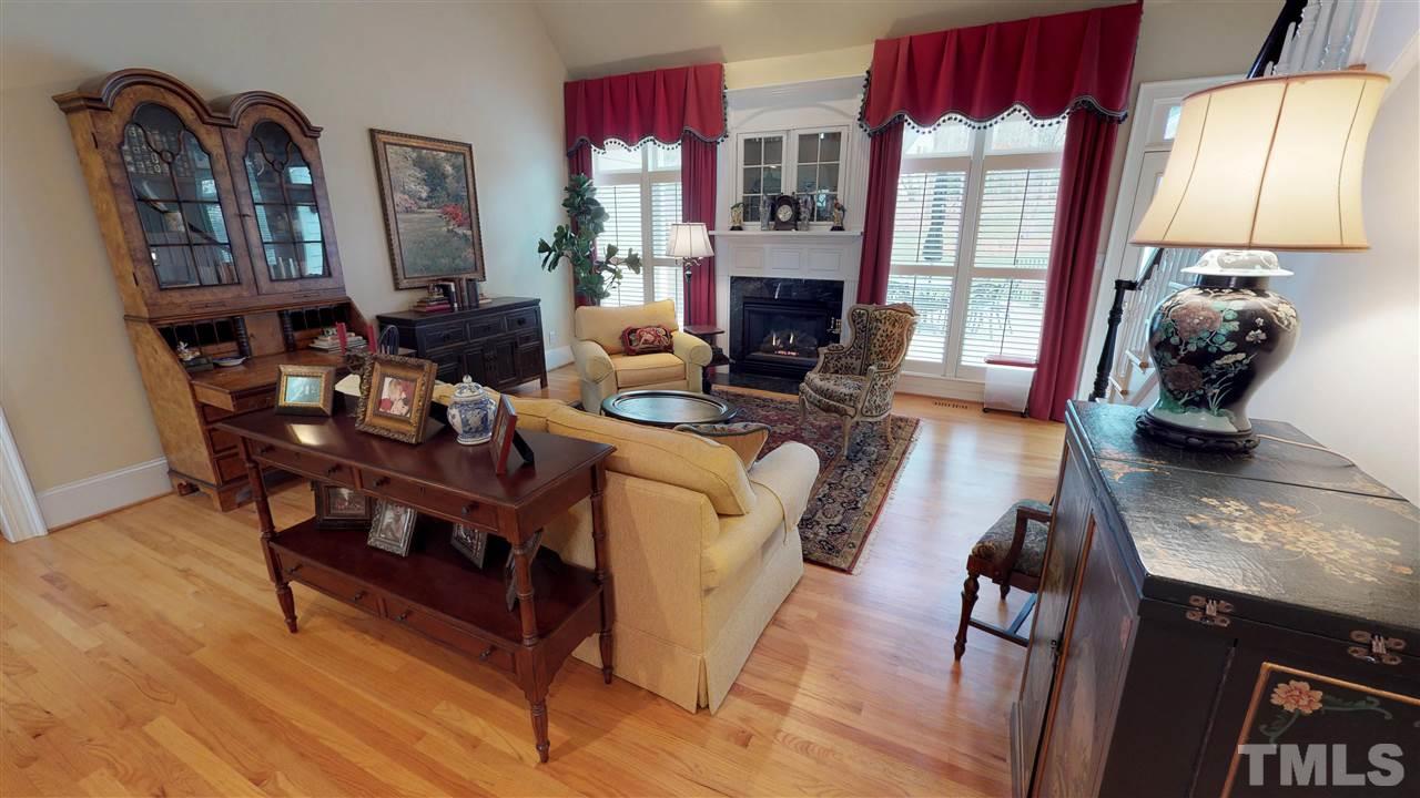 11208 Brass Kettle Road Raleigh, NC 27614 - Photo 7 of 25 a living room with fireplace furniture and a wooden floor