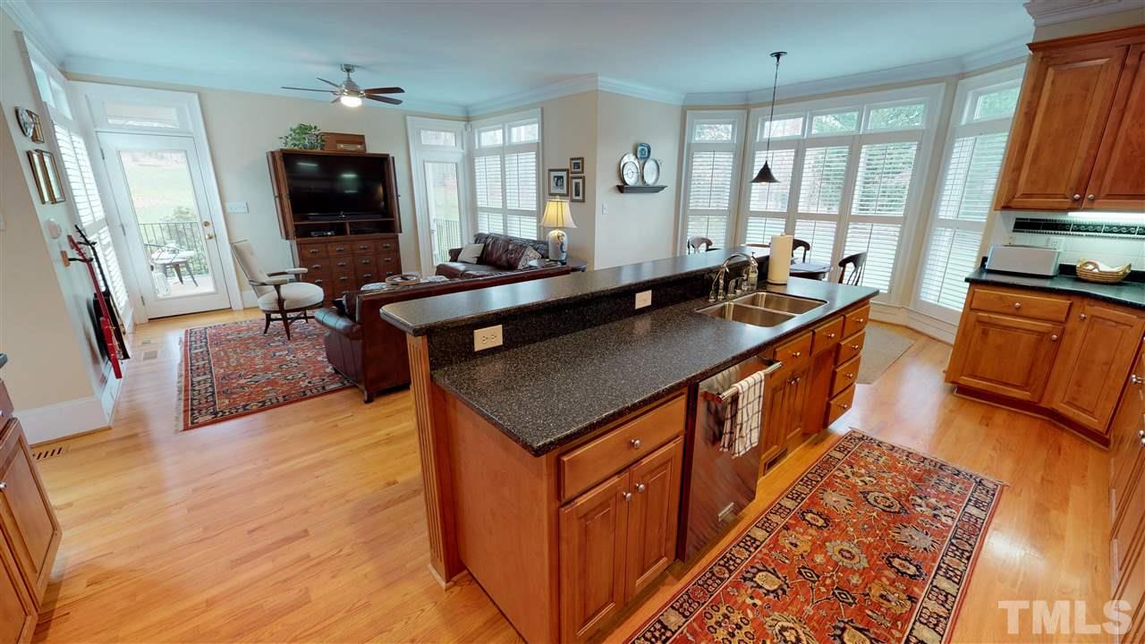 11208 Brass Kettle Road Raleigh, NC 27614 - Photo 8 of 25 a kitchen with stainless steel appliances granite countertop a sink stove and cabinets