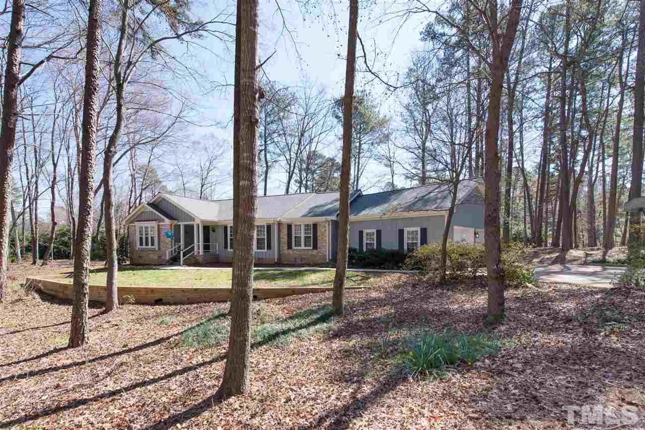 10000 Bavin Place Raleigh, NC 27613 - Photo 1 of 23 a view of a house with a yard and large trees