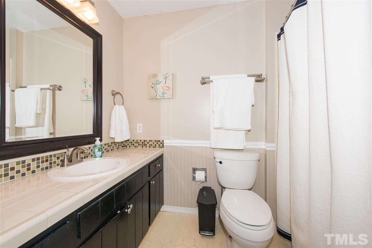 10000 Bavin Place Raleigh, NC 27613 - Photo 13 of 23 a bathroom with a granite countertop toilet sink and a mirror