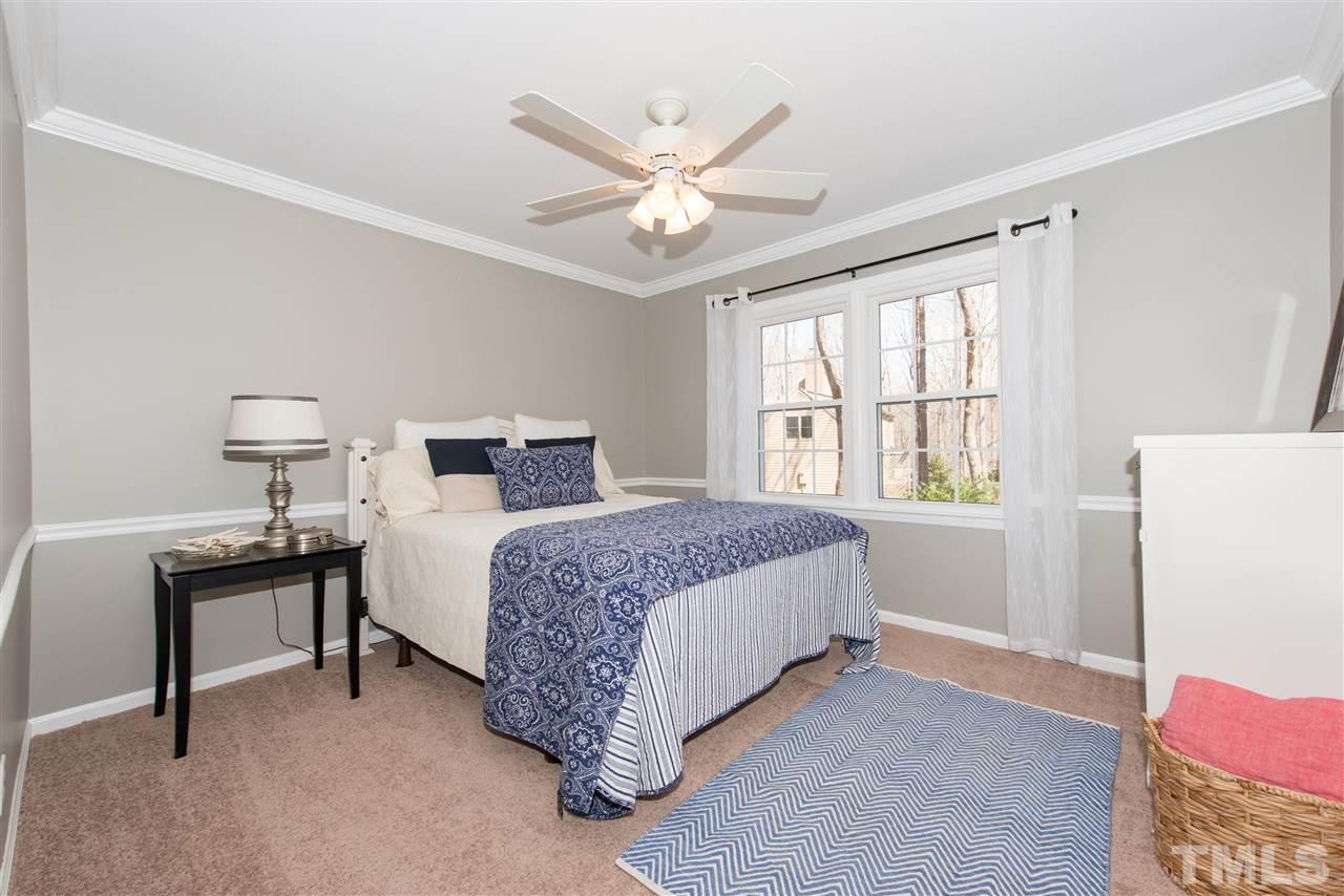 10000 Bavin Place Raleigh, NC 27613 - Photo 14 of 23 a bedroom with a bed and a table in it with window
