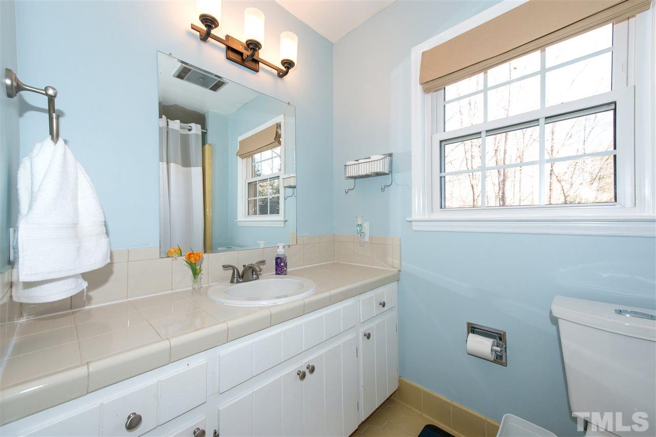 10000 Bavin Place Raleigh, NC 27613 - Photo 16 of 23 a bathroom with a sink and a mirror