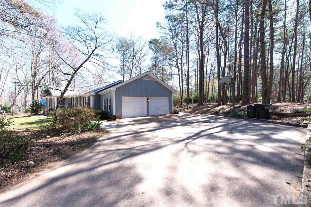 10000 Bavin Place Raleigh, NC 27613 - Photo 18 of 23 a front view of a house with a yard and garage