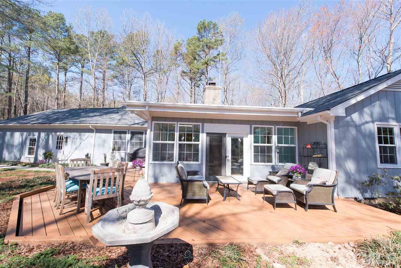 10000 Bavin Place Raleigh, NC 27613 - Photo 20 of 23 a view of a patio with a table and chairs under an umbrella