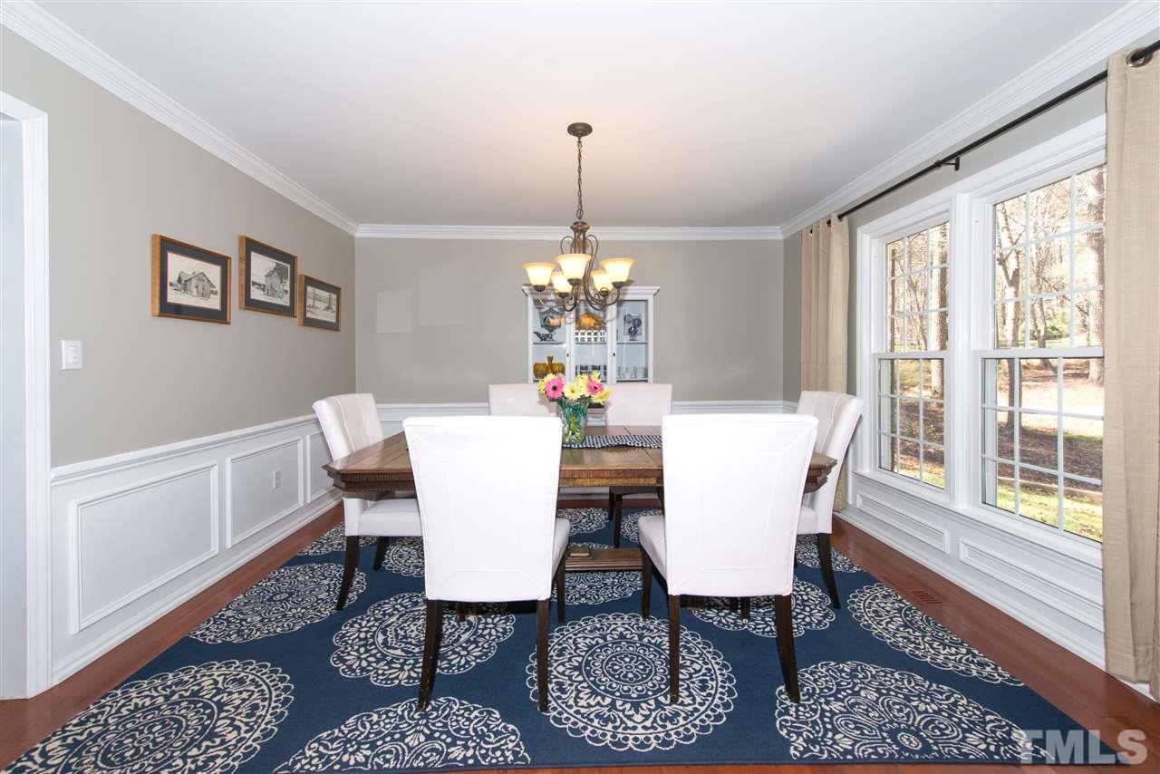 10000 Bavin Place Raleigh, NC 27613 - Photo 4 of 23 a dining room with furniture a rug and a chandelier