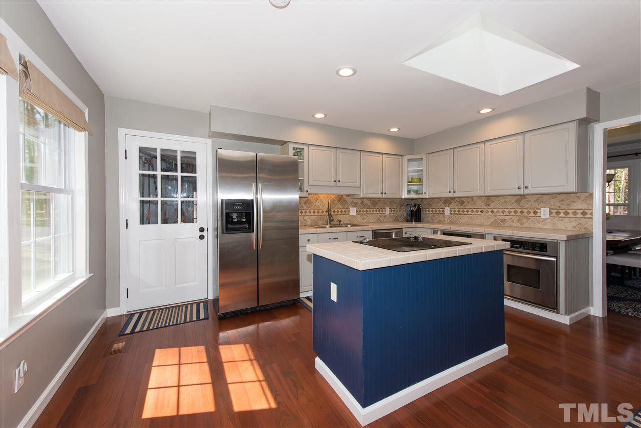 10000 Bavin Place Raleigh, NC 27613 - Photo 5 of 23 a kitchen with stainless steel appliances granite countertop a stove a refrigerator and a sink