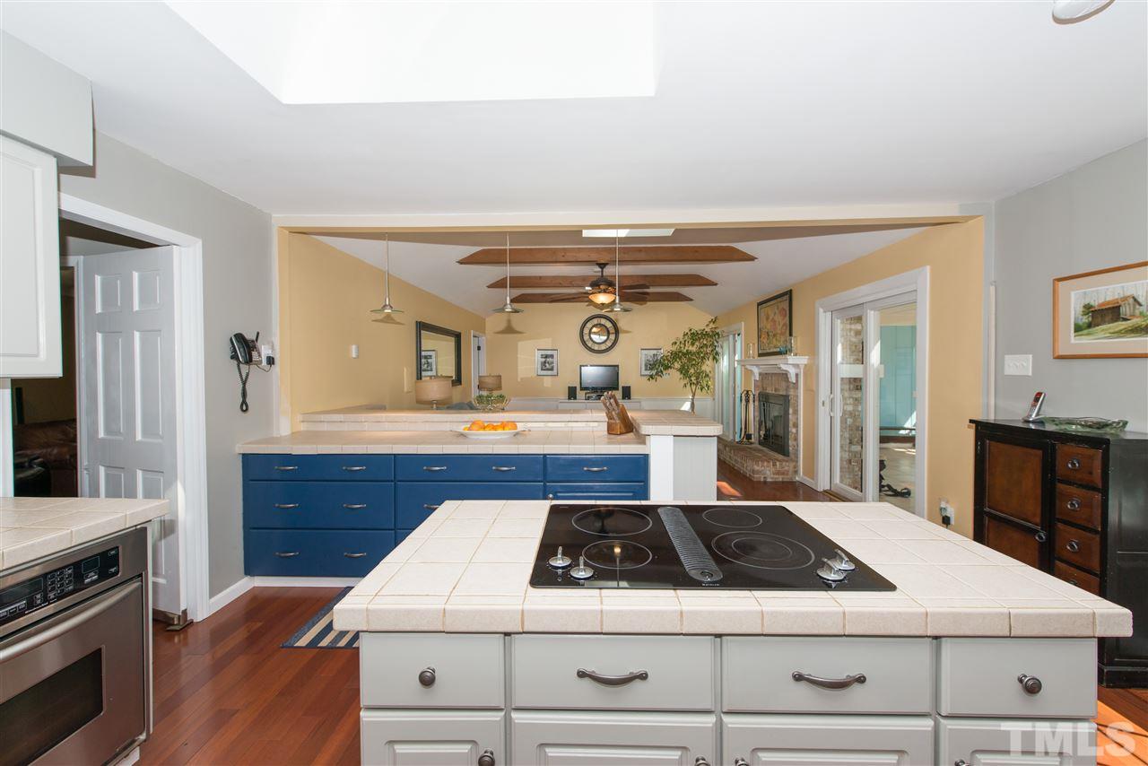 10000 Bavin Place Raleigh, NC 27613 - Photo 6 of 23 a kitchen with a stove and white cabinets