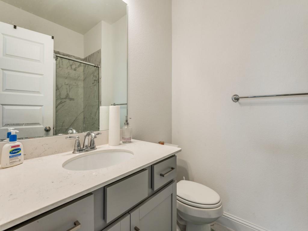 3120 Stonelake Ridge Lewisville, TX 75010 - Photo 15 of 17 a bathroom with a sink toilet vanity and tub