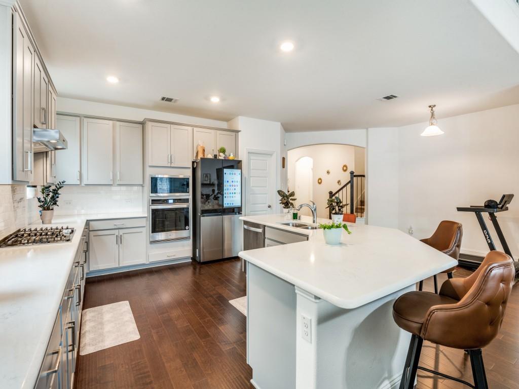 3120 Stonelake Ridge Lewisville, TX 75010 - Photo 5 of 17 a kitchen with stainless steel appliances kitchen island a refrigerator and a stove