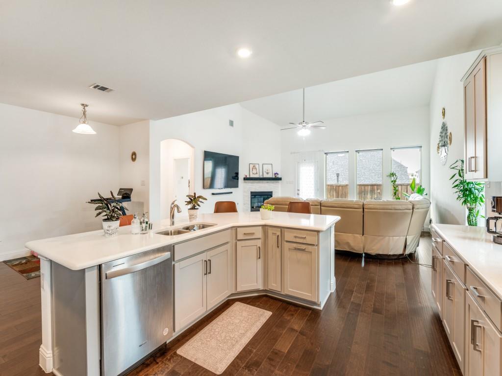 3120 Stonelake Ridge Lewisville, TX 75010 - Photo 7 of 17 a large white kitchen with a sink a window and stainless steel appliances