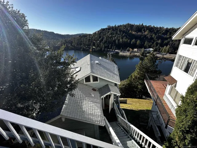a view of a chairs and table on the roof deck