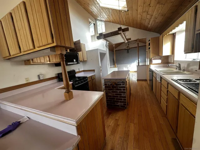 a kitchen with stainless steel appliances granite countertop a sink stove and cabinets