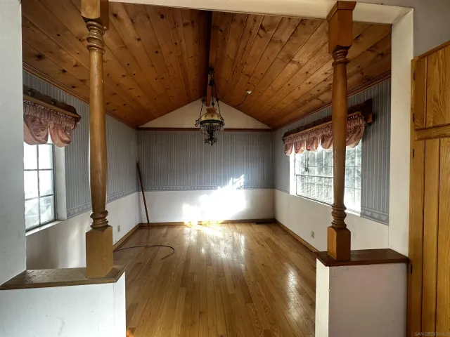 a view of a living room with granite countertop kitchen island wooden floors and floors