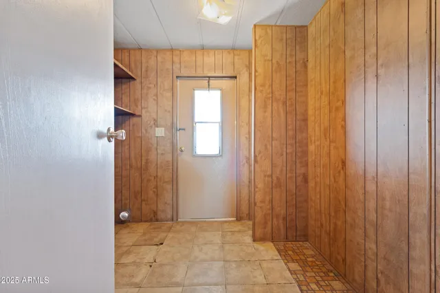 a kitchen with stainless steel appliances granite countertop a stove a refrigerator a sink dishwasher a dining table and chairs with wooden floor