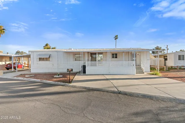 a view of a patio with a table chairs and wooden fence