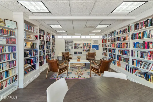 a view of a swimming pool with outdoor seating and buildings in the background