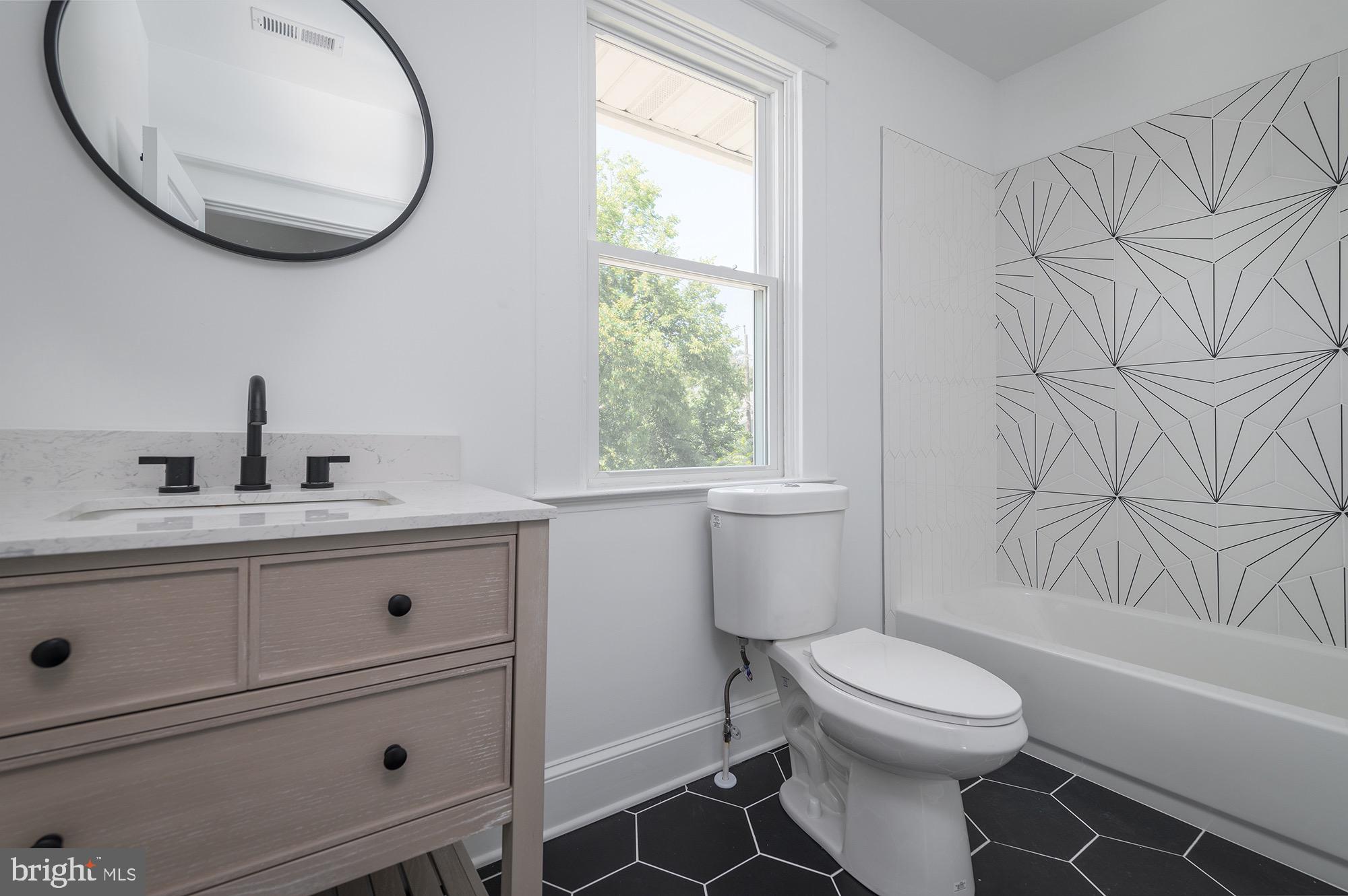 611 Plymouth Road Baltimore, MD 21229 - Photo 23 of 33 Stunning Shared Hall Bathroom w/ Designer Tile