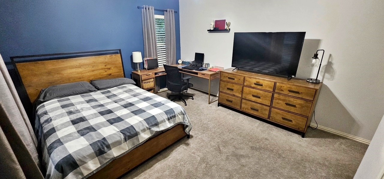 201 Smith Street Columbus, TX 78934 - Photo 13 of 20 a bedroom with a bed and flat screen tv