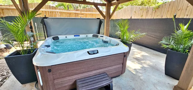 a wooden bench sitting in a backyard