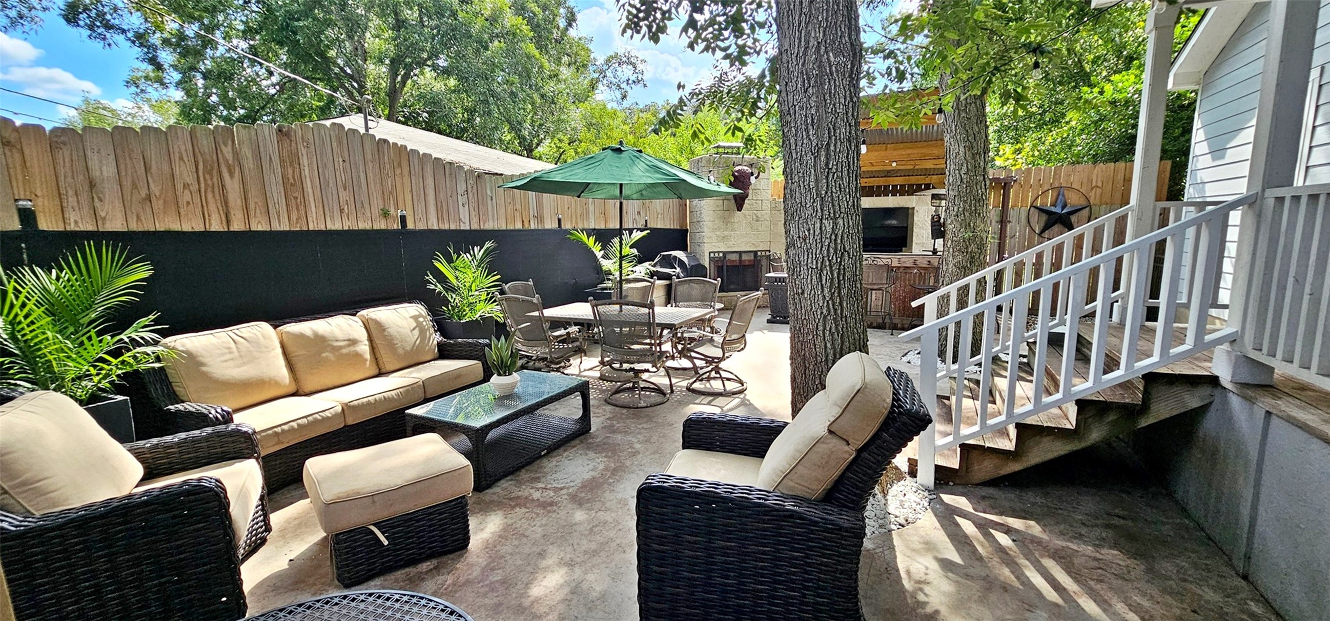 201 Smith Street Columbus, TX 78934 - Photo 18 of 20 a view of a patio with couches chairs and a table and chairs with wooden fence