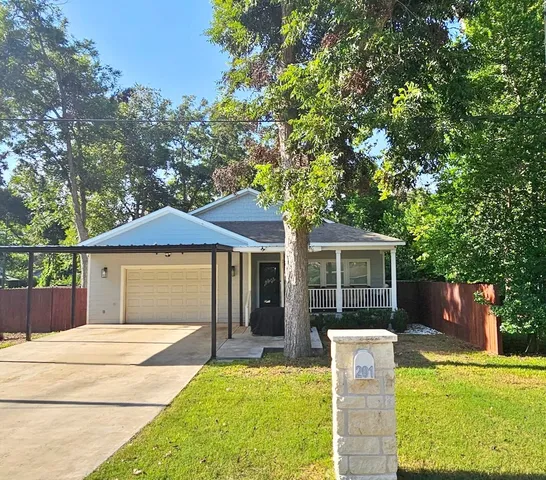 a view of a house with a backyard and a patio