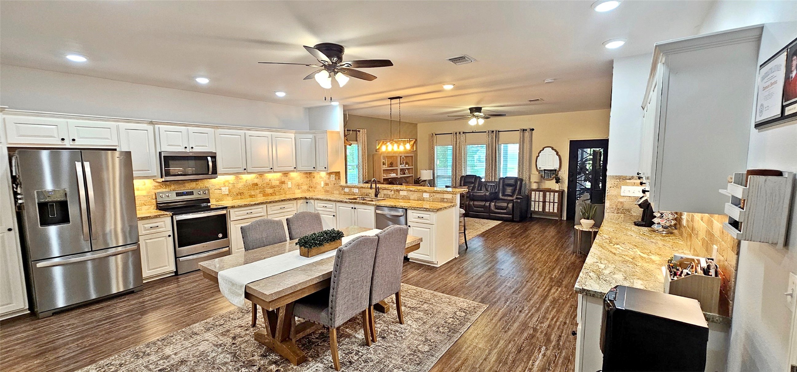 201 Smith Street Columbus, TX 78934 - Photo 4 of 20 a large kitchen with a table chairs refrigerator and microwave