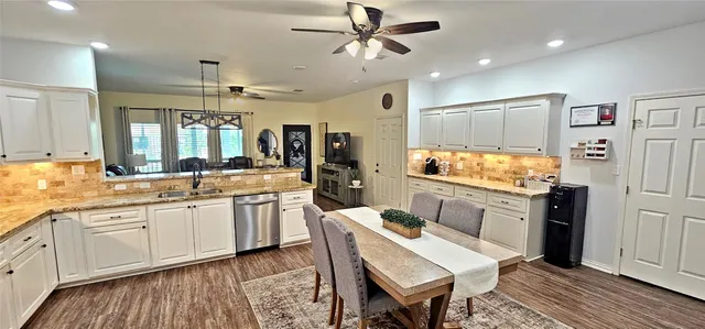 a large kitchen with a table and chairs