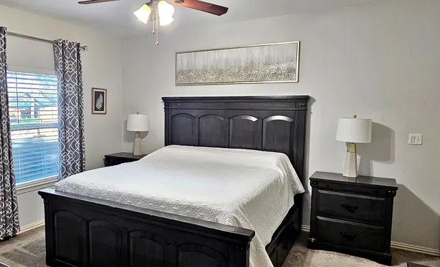 a bedroom with a bed and a lamp