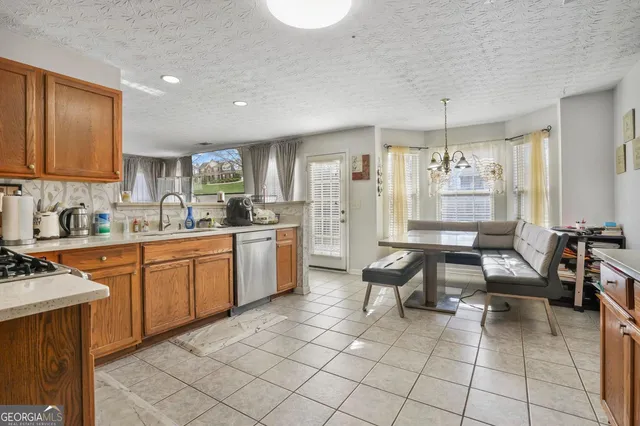 a kitchen with cabinets a sink and appliances