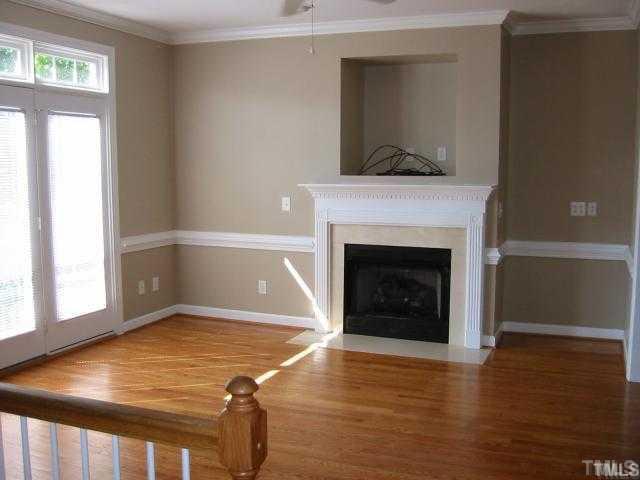 6101 Bordesley Court Raleigh, NC 27609 - Photo 2 of 6 a living room with a fireplace