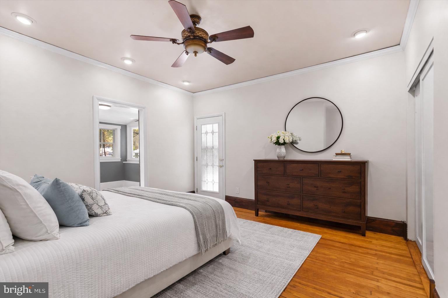 23320 Watson Road Leesburg, VA 20175 - Photo 21 of 51 a bedroom with a bed a mirror and a chandelier