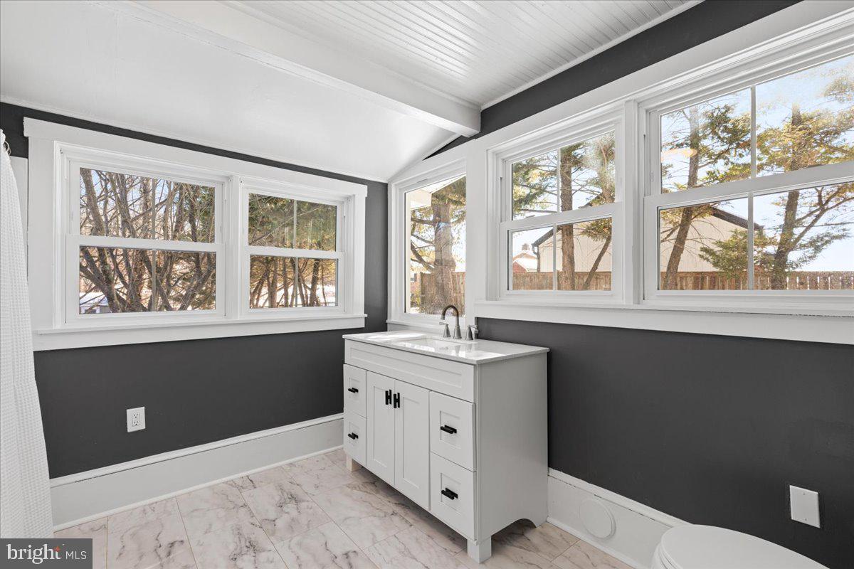 23320 Watson Road Leesburg, VA 20175 - Photo 24 of 51 a kitchen with a window wooden cabinets and sink