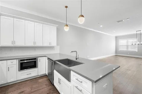 a kitchen with stainless steel appliances granite countertop a sink stove and cabinets