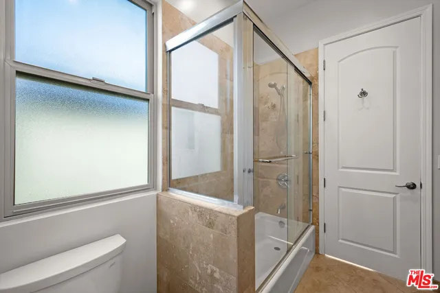 a bathroom with a shower and a sink