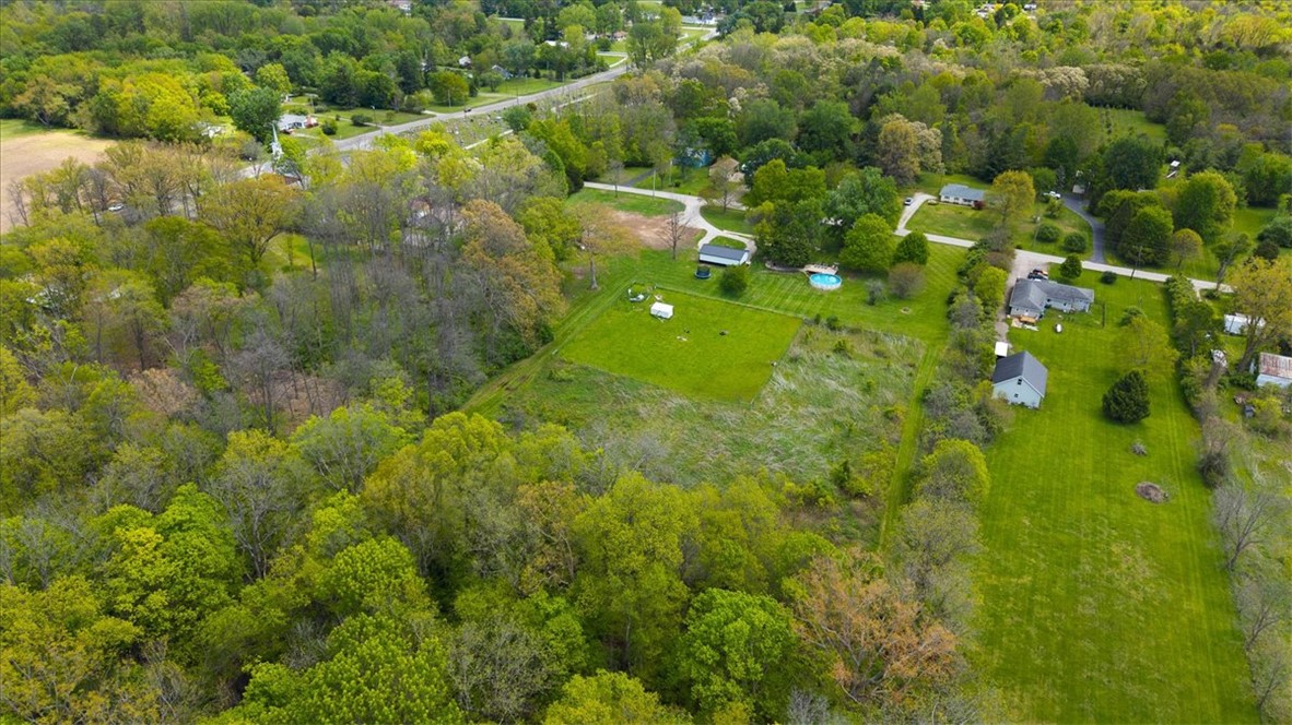 5120 Wheelock Road Troy, OH 45373 - Photo 56 of 67 Expansive green spaces and mature trees surround this property, offering a tranquil and private setting.