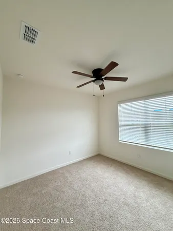 an empty room with a empty space and windows