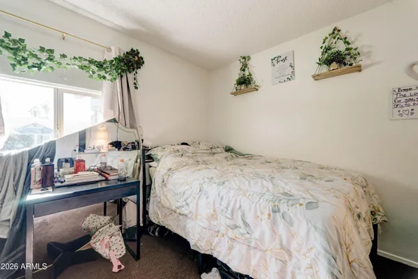 a bedroom with bed and a closet