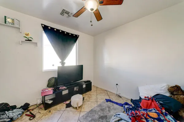 a bedroom with bed and a window