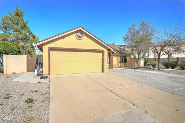 a view of a house with a yard and garage