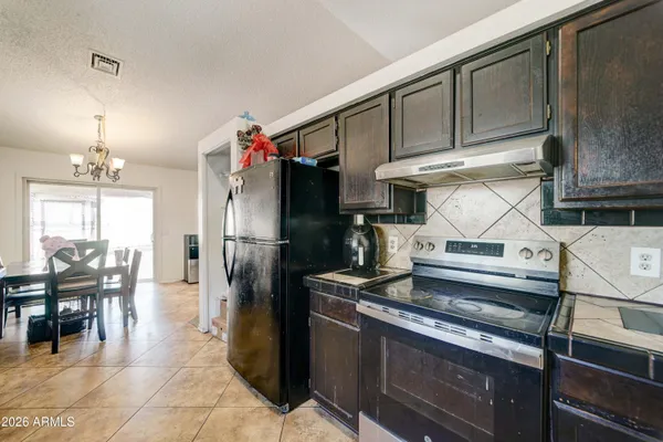 a kitchen with stainless steel appliances granite countertop sink stove and table