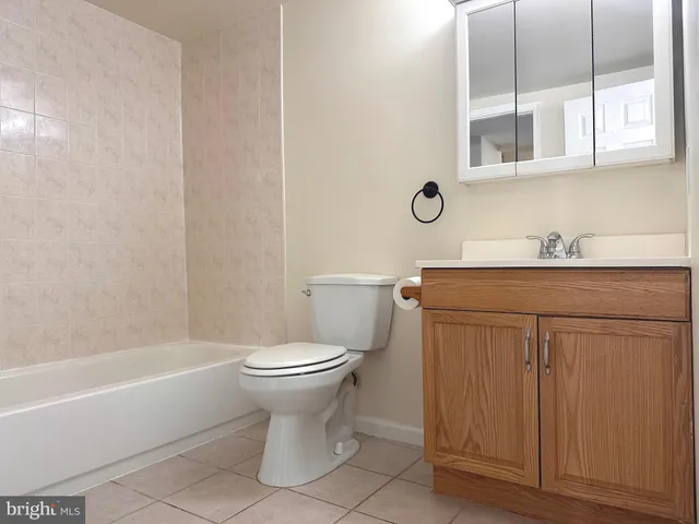 a bathroom with a sink toilet and mirror