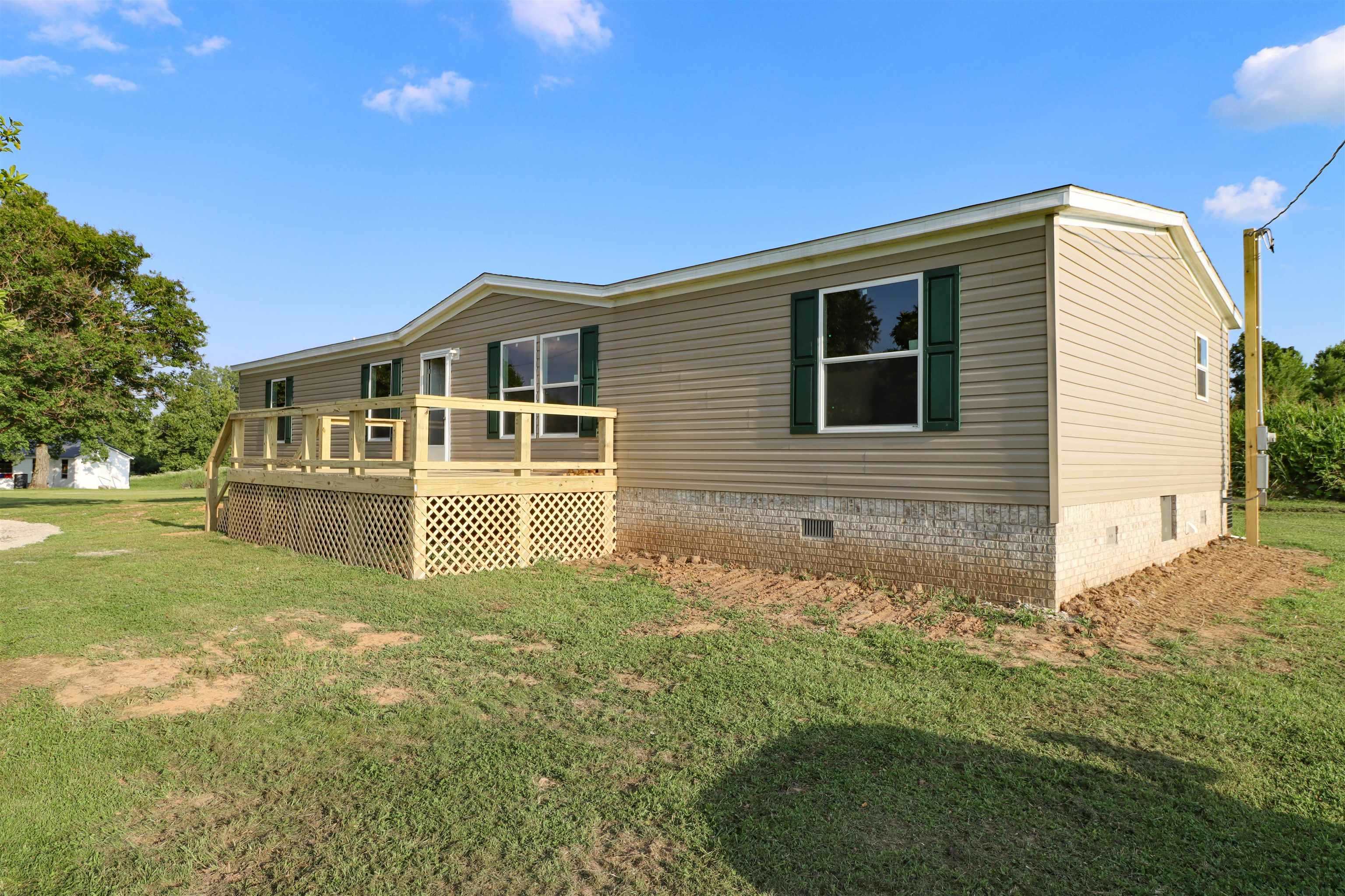 6483 Hwy 19 Highway West Ripley, TN 38063 - Photo 2 of 33 a front view of a house with garden