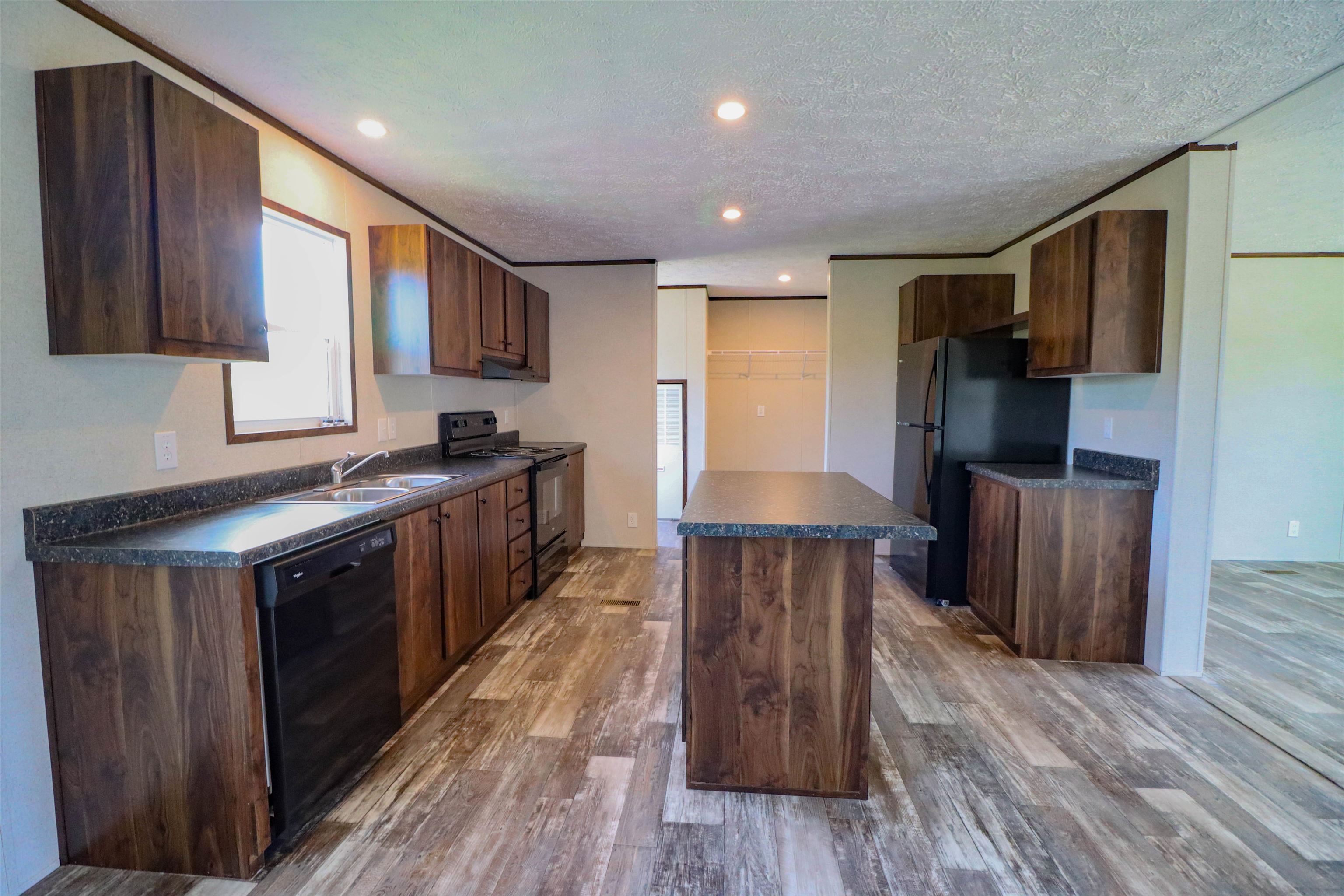 6483 Hwy 19 Highway West Ripley, TN 38063 - Photo 8 of 33 a kitchen with stainless steel appliances granite countertop a refrigerator a stove top oven a sink and dishwasher