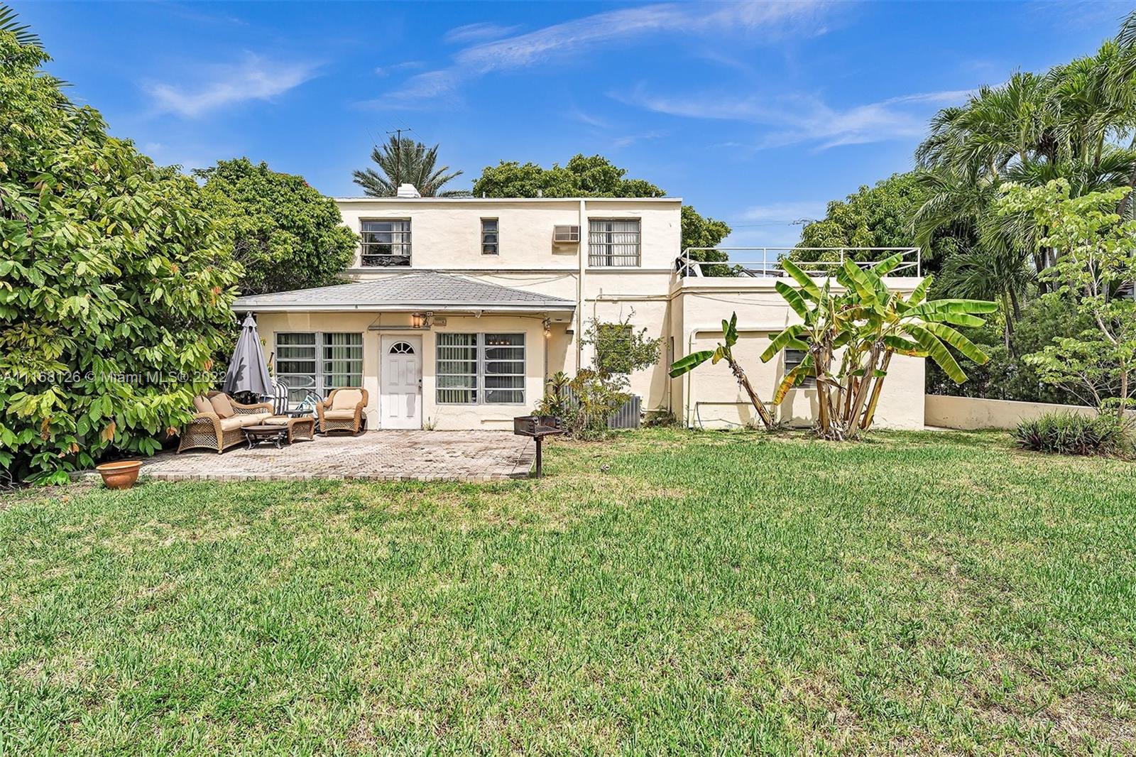 2033 North Bay Road Miami Beach, FL 33140 - Photo 31 of 38 a front view of a house with porch and garden